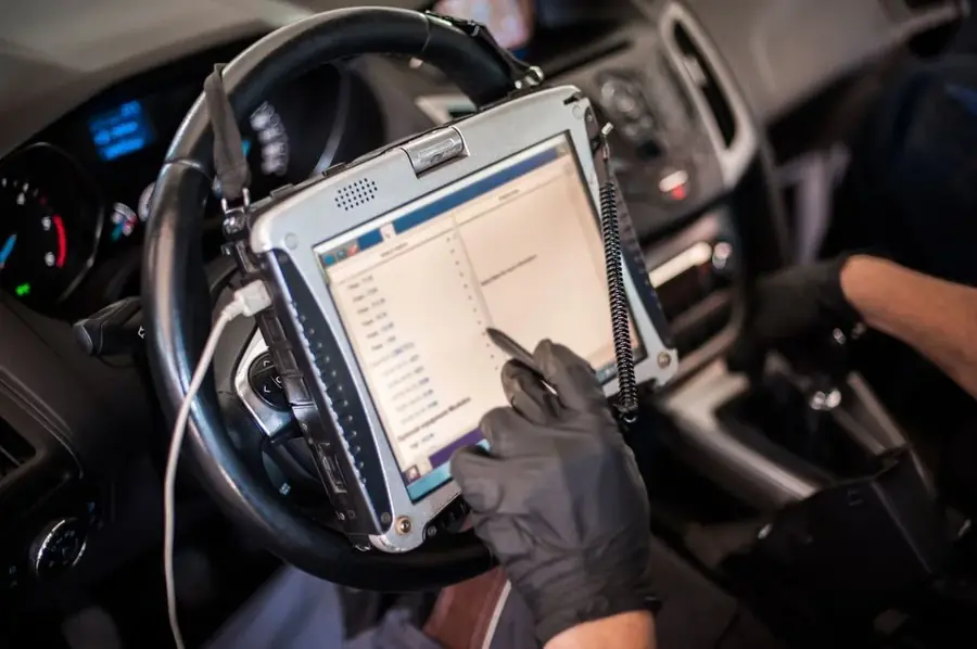 Diagnostic tablet being used inside a vehicle
